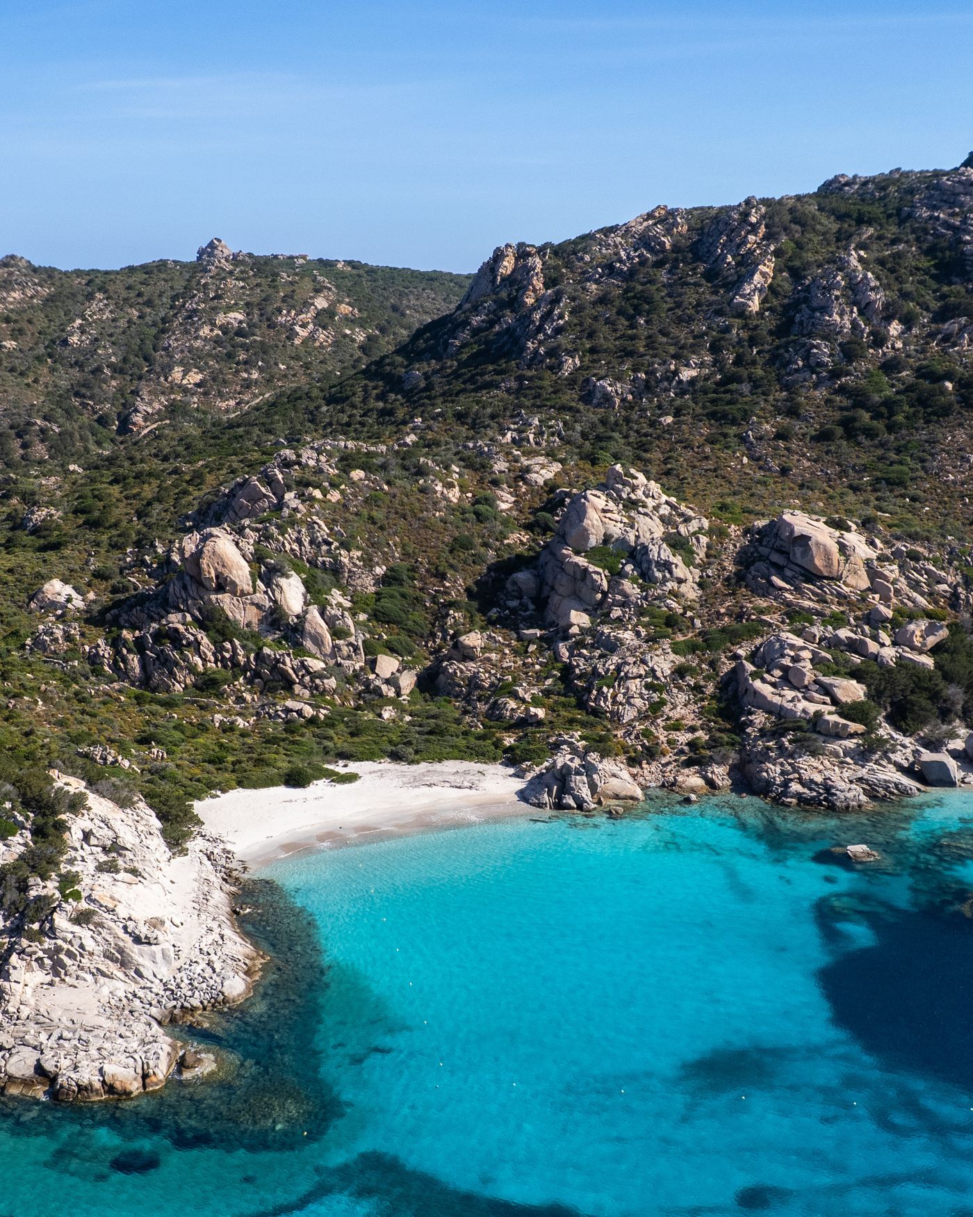 A turquoise cove framed by granite rocks on the Gulf of Orosei